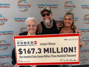 James Farthing is pictured with his mother, left, when they picked up their Powerball cheque.