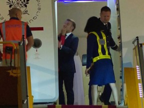 In this grab taken from video, France's President Emmanuel Macron prepares to disembark a plane on arrival, in Hanoi, Vietnam, Sunday, May 25, 2025.