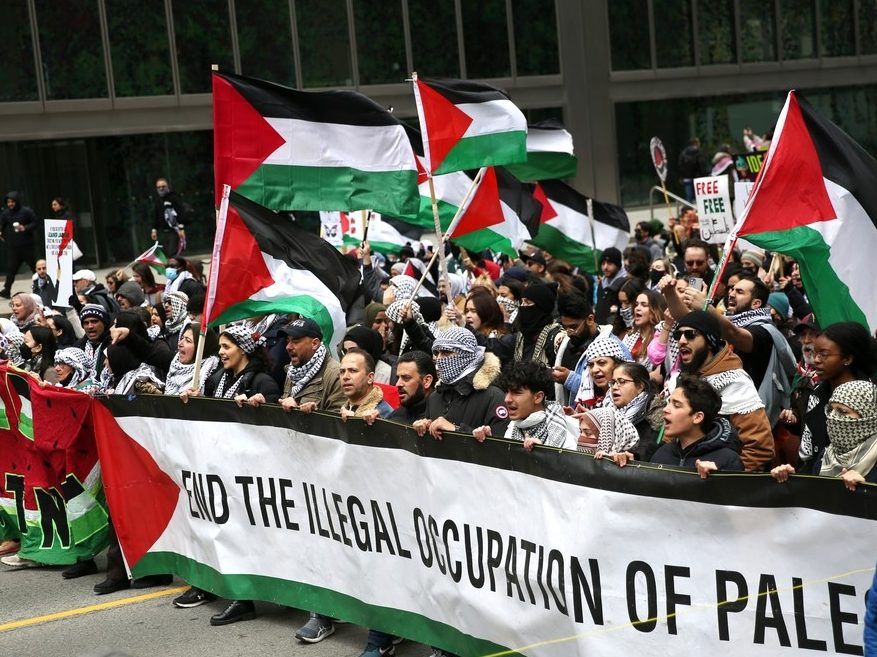 Protesters carry Palestinian flags and shout slogans during a demonstration march on April 21, 2024 in Toronto, Ontario. Protesters have demanded a ceasefire in the current conflict in the Gaza Strip.