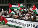 Protesters carry Palestinian flags and shout slogans during a demonstration march on April 21, 2024 in Toronto, Ontario. Protesters have demanded a ceasefire in the current conflict in the Gaza Strip.