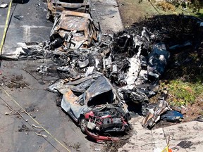Debris covers the ground after a small plane crashed into a San Diego neighbourhood, setting homes and cars on fire and forcing evacuations early Thursday, May 22, 2025.