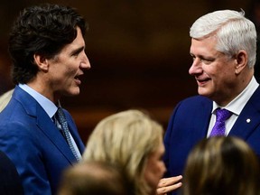 Former prime ministers Justin Trudeau (left) and Stephen Harper are pictured ahead of King Charles’ speech from the Throne to open the first session of the 45th Parliament of Canada at the Senate of Canada, in Ottawa on May 27, 2025.