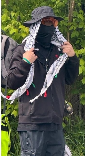  Dressed in full disguise, this pro-Hamas supporter was along the side of the 56,000-strong Walk with Israel event on Sunday carrying what appeared to be a grenade.