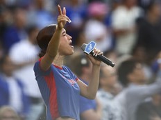 Music artist Nezza sings the national anthem prior to a baseball game between the Los Angeles Dodgers and the San Francisco Giants on June 14.