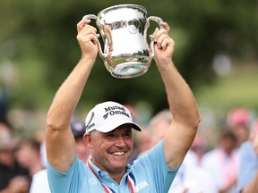 Padraig Harrington hoists the Francis D. Ouimet Memorial Trophy.