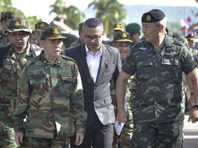 In this photo released by the Thai Royal Thai Army, Cambodian Chief of Army Mao Sophan, left, meets with Thailand Chief of Army Gen. Pana Claewplodtook, right, at a border checkpoint in Surin province, Thailand, May 29, 2025.