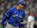 Toronto Blue Jays' George Springer shouts as he runs the bases with a home run in the eighth inning against the Cleveland Guardians in Cleveland.