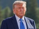 U.S. President Donald Trump takes part in the family photo at the G7 summit in Kananaskis, Alta., Monday, June 16, 2025. The president wore an extra lapel pin with both the Canadian and American flags.