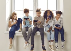 Group of children read social media on mobile phones.
