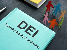 Book about DEI diversity, equity and inclusion and paper figurines.