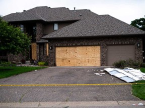 Boards cover the doors and windows outside the home of DFL State Rep. Melissa Hortman on June 15, 2025 in Brooklyn Park, Minn. Hortman and her husband, Mark Hortman, were shot and killed yesterday morning.