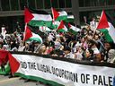 Protesters carry Palestinian flags and shout slogans during a demonstration march on April 21, 2024, in Toronto.