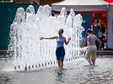 In this file photo, tourists beat the heat at the fountain at Nathan Phillips Square in Toronto on Friday July 12, 2024.