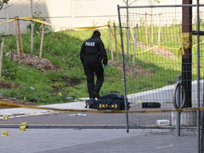 A Toronto Police officer is pictured at a crime scene in Lawrence Heights on June 4, 2025, the day after one person was killed and five wounded in a mass shooting. (Jack Boland, Toronto Sun)