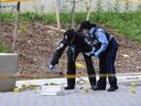 Toronto Police forensic officers walk through a large crime scene on Wednesday, June 4, 2025, behind a condo near Yorkdale Mall. Gunmen sprayed bullets into a crowd in the Flemington Rd.- Zachary Crt. area Tuesday, June 3, 2025, killing one victim and wounding five.