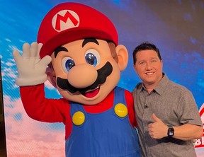 Marc Saltzman, seen here with Mario, gives a big thumbs up to the Nintendo Switch 2 after it was released on Thursday, June 5, 2025.