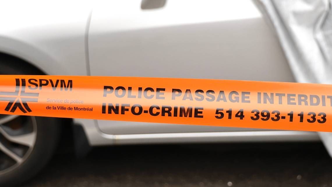 Police tape near a vehicle in Montreal.
