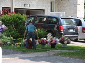 Well wishers have left bouquets in front of the Pickering home where Eleanor Doney lived. A 14-year-old boy has been charged with first-degree murder in connection with her stabbing death. Pictured on June 2, 2025. (Jack Boland, Toronto Sun)