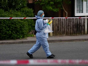 Forensic officers work at the scene after a sword attack on April 30, 2024 in Hainault, England.