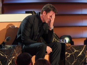 Tom Brady laughing into hand during The Greatest Roast of All Time.
