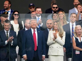 President Donald Trump, first lady Melania Trump, and Defense Secretary Pete Hegseth, left, attend a military parade commemorating the Army's 250th anniversary, coinciding with his 79th birthday, Saturday, June 14, 2025, in Washington.