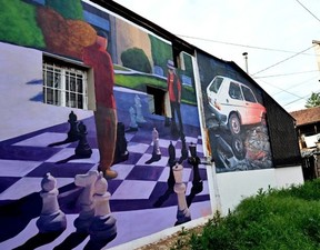 A photo shows old buildings renovated with murals by Bosnian street artist Benjamin Cengic and his creative team who seek to “create bonds” between peopleELVIS BARUKCIC/AFP