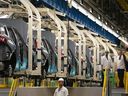 Workers continue vehicle assembly shortly before the line was shut down for an event at the Honda of Canada Manufacturing Plant 2 in Alliston, Ontario, on April 25, 2024.