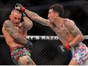 Max Holloway of the United States (R) strikes Dustin Poirier of the United States during their lightweight bout during UFC 318: Holloway vs Poirier 3 at the Smoothie King Center on July 19, 2025 in New Orleans, Louisiana.