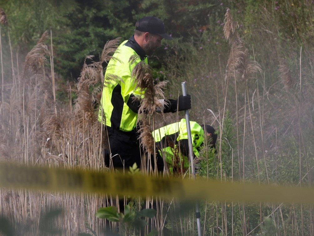  Toronto Police officers spent the morning collecting evidence after a body was found along the side of the eastbound lanes of Hwy. 401, west of Whites Rd., in Pickering on Friday, July 11, 2025.