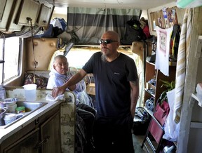 Carlos Perez stands inside an RV, where he lives with his brother, Selvin, left, in the Bayview neighborhood of San Francisco, Monday, July 14, 2025.