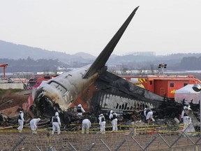 Rescue team members work at the site of a plane crash at Muan International Airport in Muan, South Korea on Dec. 31, 2024.