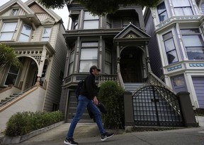 man walks past the house where the original members of the Grateful Dead music group lived
