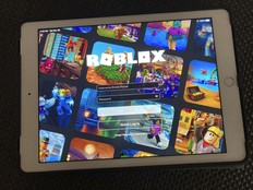 The gaming platform Roblox is displayed on a tablet.