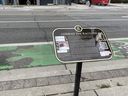 A plaque honouring the 10th anniversary of the death of Conrad the Raccoon, whose body was found on a Toronto sidewalk in July 2015, is pictured on Tuesday, July 22, 2025.