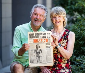 Marnie Wilson and her husband Mark hold a copy of the Toronto Sun from Aug.1, 1975, while posing for a photo in Toronto's Liberty Village on Tuesday July 29, 2025. Back on July 31st, 1975, Marnie called in sick to work, went to the beach and ended up on the front page of the Toronto Sun.