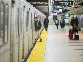 People board a TTC train.