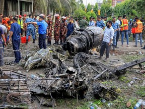 Bangladesh's fire service and security personnel conduct a search and rescue operation after an Air Force training jet crashed into a school in Dhaka on July 21, 2025.