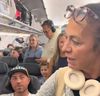 A violent fight broke out among a crowd of passengers on the plane when the lawyer tried to jump the line and get out first.