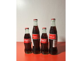 Regular (short) and Mexican (tall) bottles of Coca-Cola, made with high-fructose corn syrup and cane sugar, respectively.