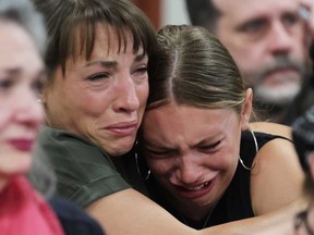 Dylan Mortensen gets a hug after speaking at the sentencing hearing of Bryan Kohberger at the Ada County Courthouse, for his sentencing hearing, Wednesday, July 23, 2025, in Boise, Idaho, for brutally stabbing four University of Idaho students to death nearly three years ago.