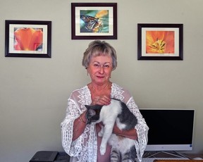 Linda Keesee cuddles her cat, Annabelle, at her condo at Avalon.