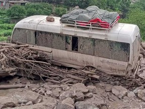 This handout photograph released on July 22, 2025 by the Government of Gilgit-Baltistan shows a stucked passenger van in the landslide hit area in Babusar, Gilgit-Baltistan region.