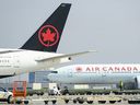 Air Canada planes sit on the tarmac at Pearson International Airport in Toronto on Wednesday, April 28, 2021.