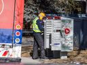Canada Post delivers to a public mailbox in Calgary on Tuesday, March 18, 2025.
