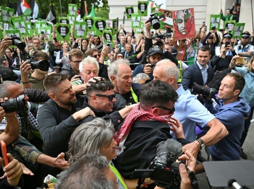 Irish rap group Kneecap band member, Naoise O Caireallain, who performs under the stage name Moglai Bap smiles as he arrives with band mate Liam O'Hanna, who performs under the stage name Mo Chara at Westminster Magistrates' Courts.