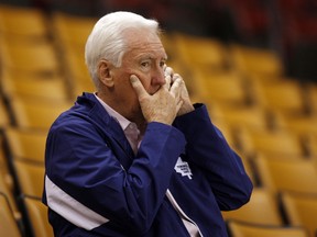 Former Toronto Maple Leafs general manager Cliff Fletcher covers his mouth while on the phone in 2008.