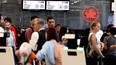 Passengers line up for assistance at Trudeau airport after flight cancellations and delays were announced as Air Canada prepares to lock out its flight attendants, on Friday, Aug. 15, 2025.