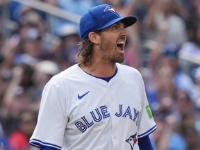 Blue Jays pitcher Kevin Gausman reacts after a successful pickoff