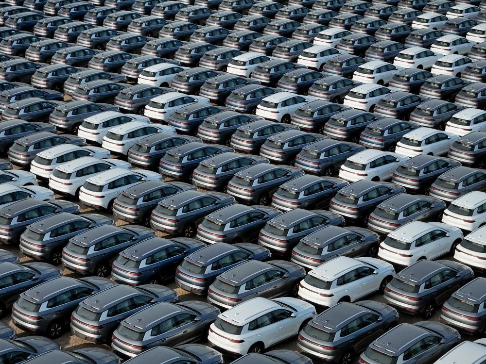 This photo taken on April 18, 2024 shows BYD electric cars for export waiting to be loaded onto a ship at a port in Yantai, in eastern China's Shandong province.  