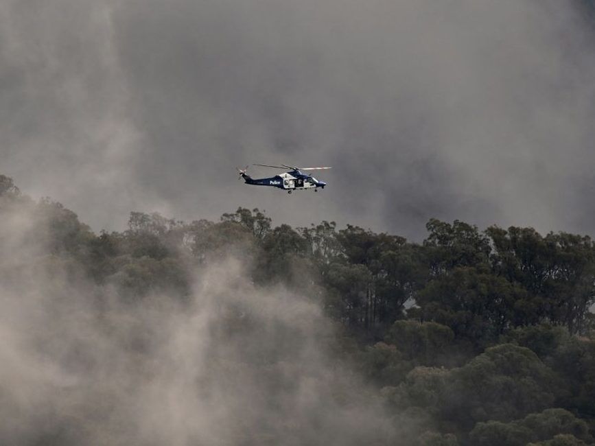 Australian police helicopters searched for a gunman suspected of killing two officers